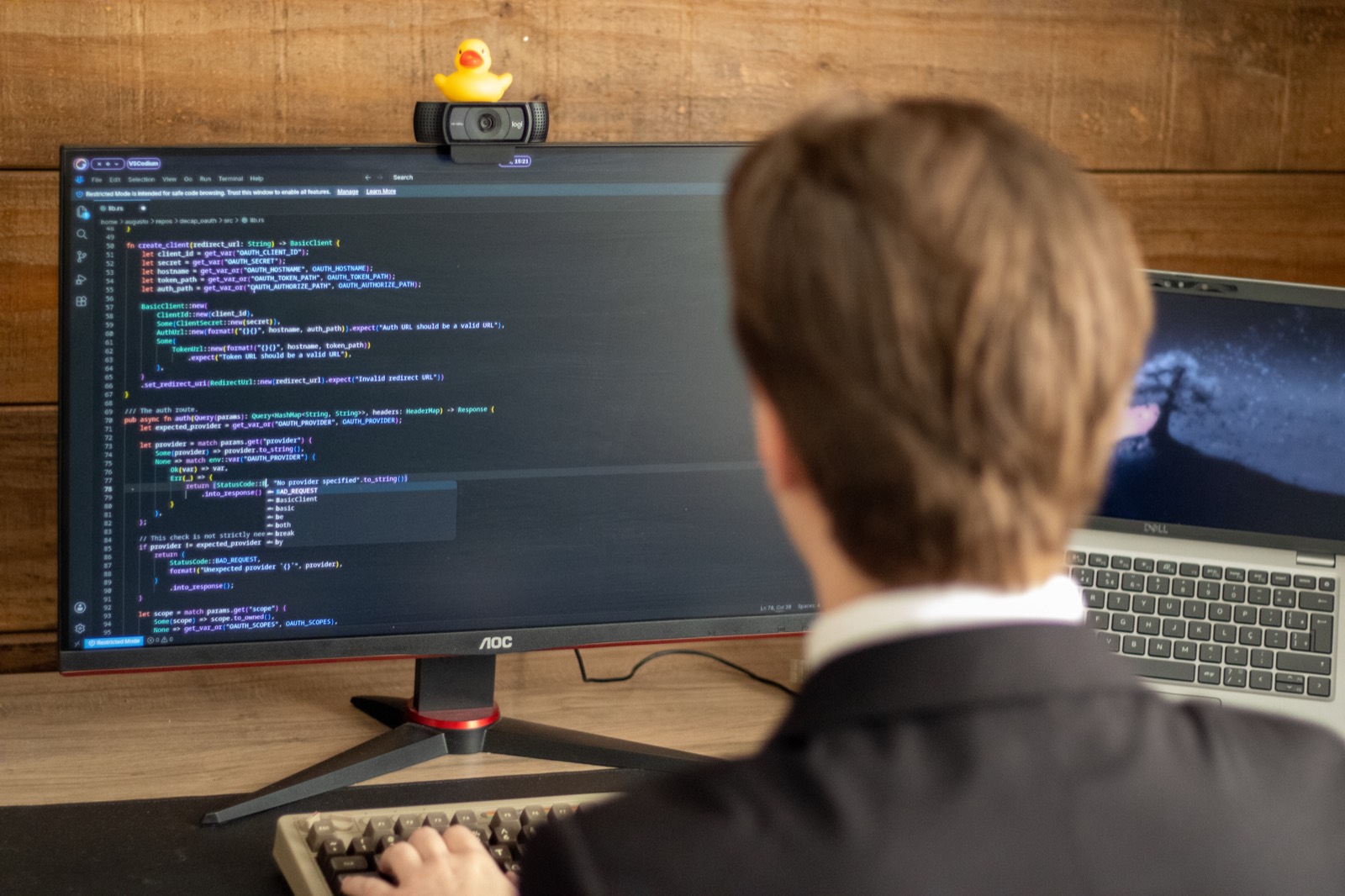 Augusto at work in his office, focused on code